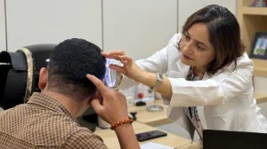 doctor checking results of hair transplantation in Nepal