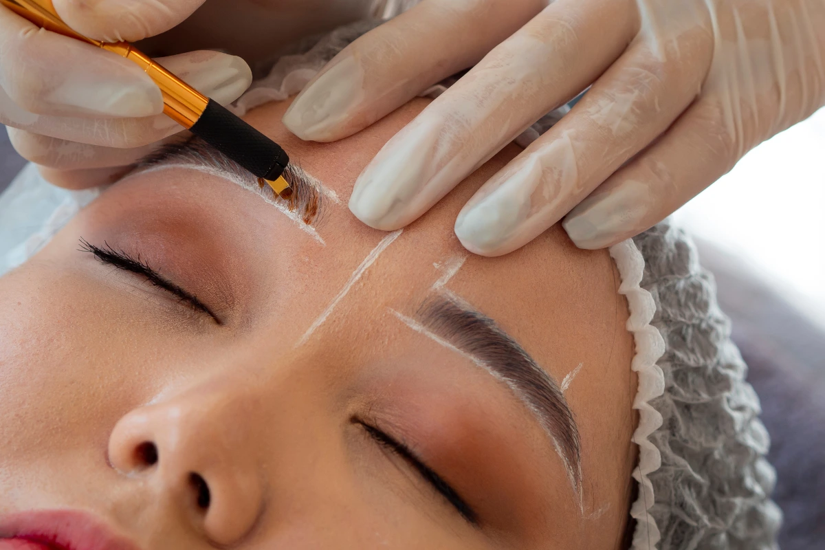 performing microblading treatment in young girl